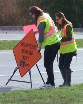 Putting up highway signage warning of roadside workers