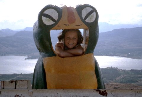 Little girl looking out of the mouth of a Garbage Gobbler bin