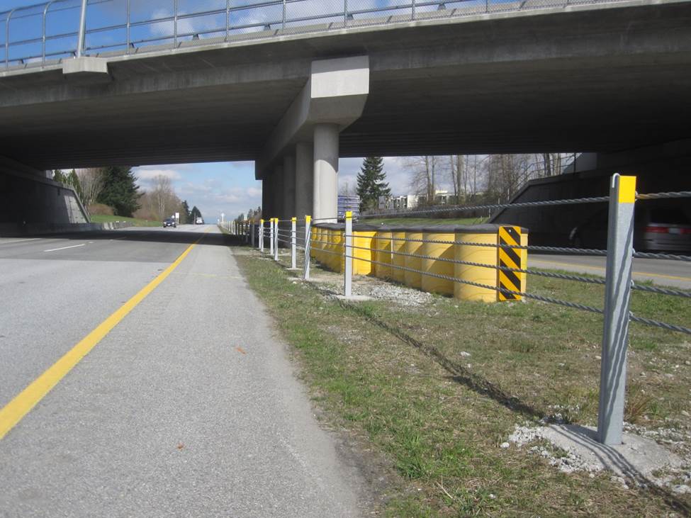 Cable barrier with crash attenuator in the background.