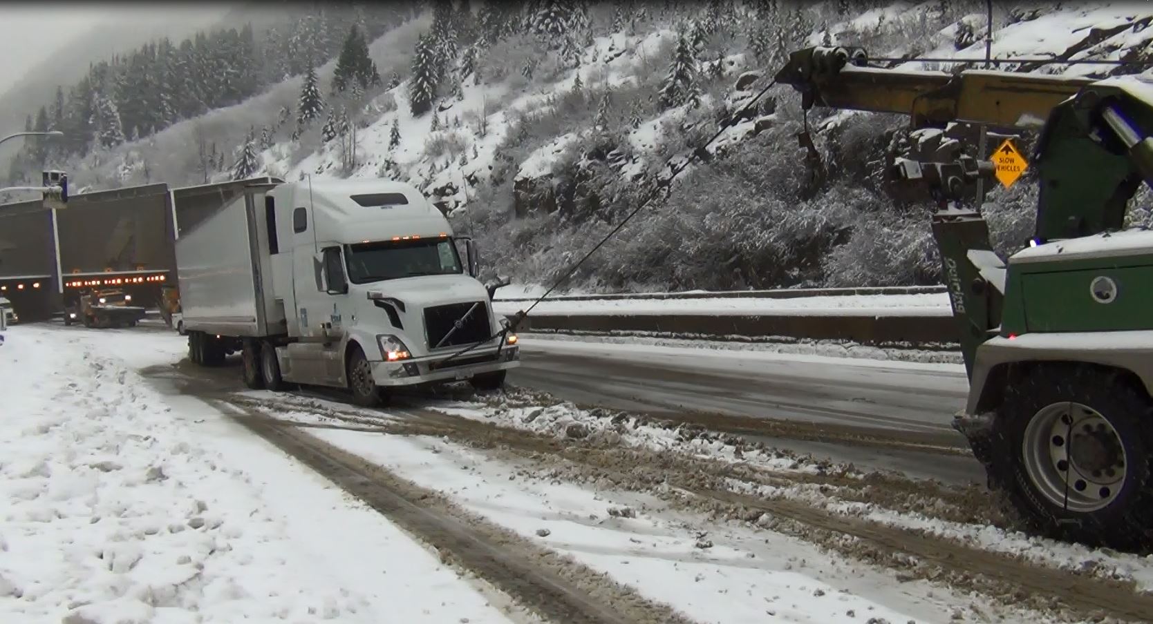 Commercial vehicle gets traction help from tow truck on Coquihalla