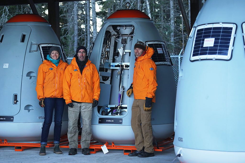 3 avalanche techs stand with o-bellx units