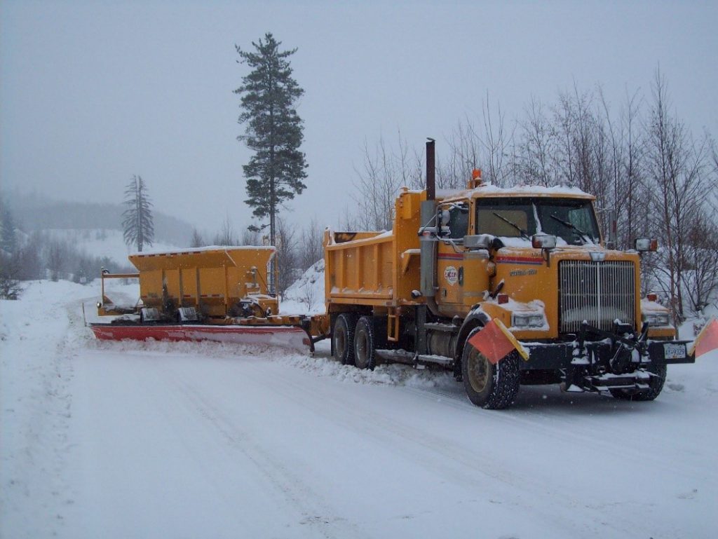 A tow plow attached to a plow truck.