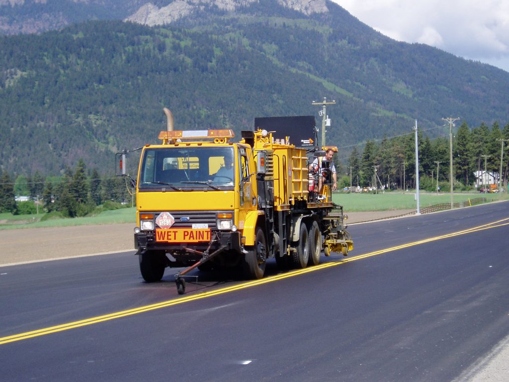 A line marking machine paints a stretch of highway in BC.
