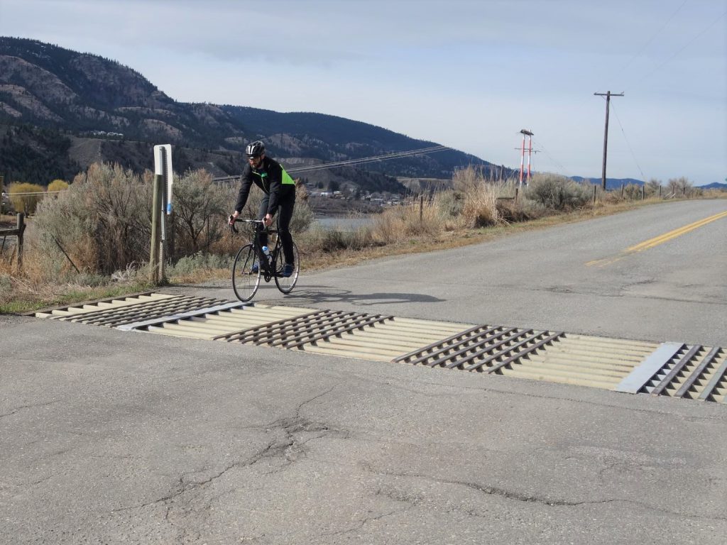 Cyclist travelling over retrofitted cattle guard