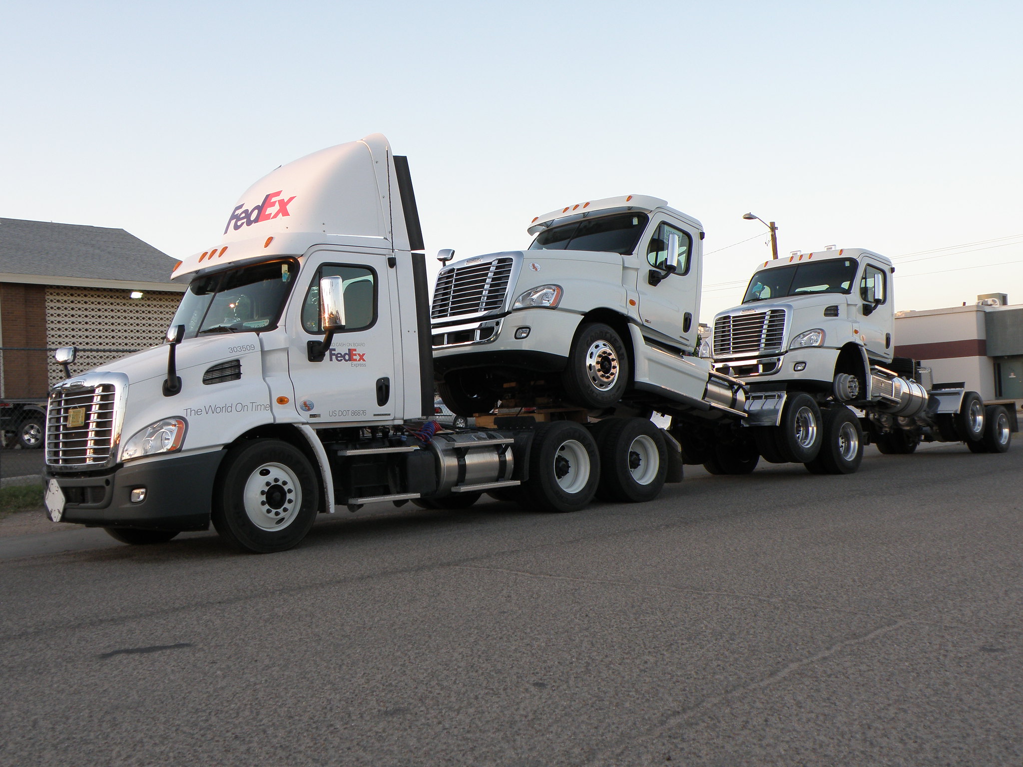 Three piggybacking trucks