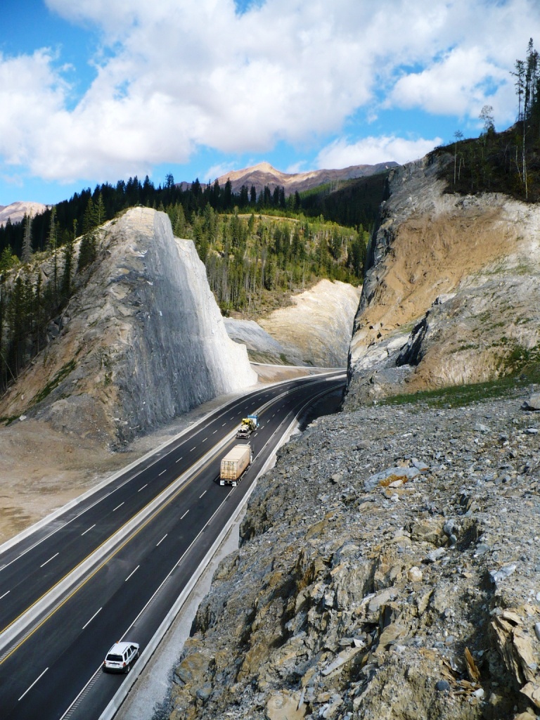 traffic moves through large rock with cut through on the Trans Canada highway near Revelstoke