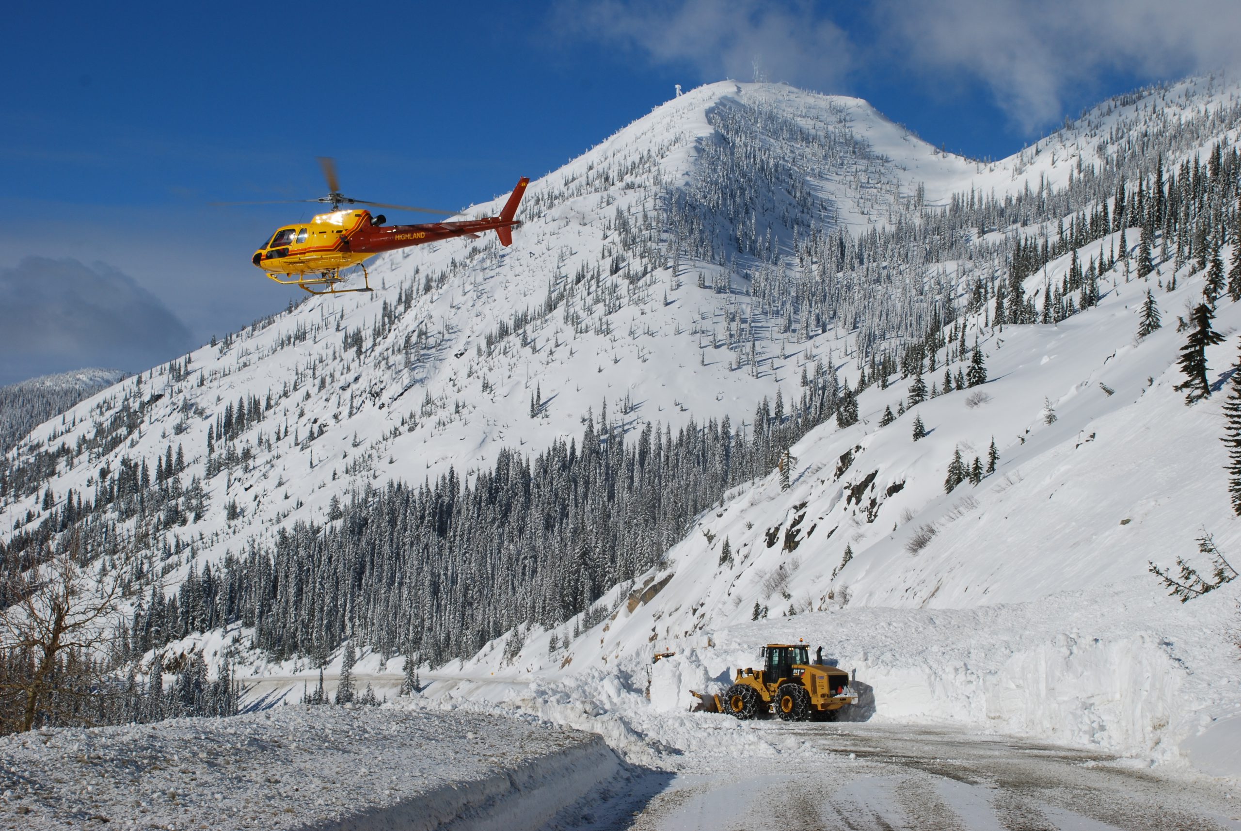 Removing avalanche deposit after control work in Kootenay Pass.